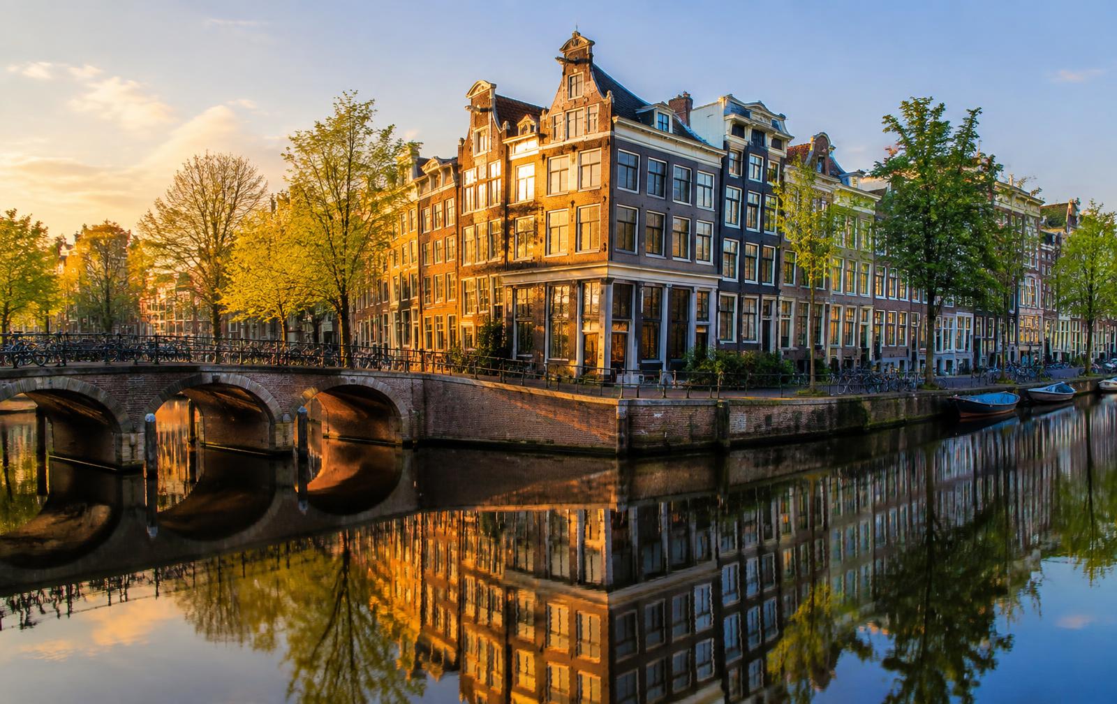 A view of Amsterdam's canals and historic houses in the morning sun