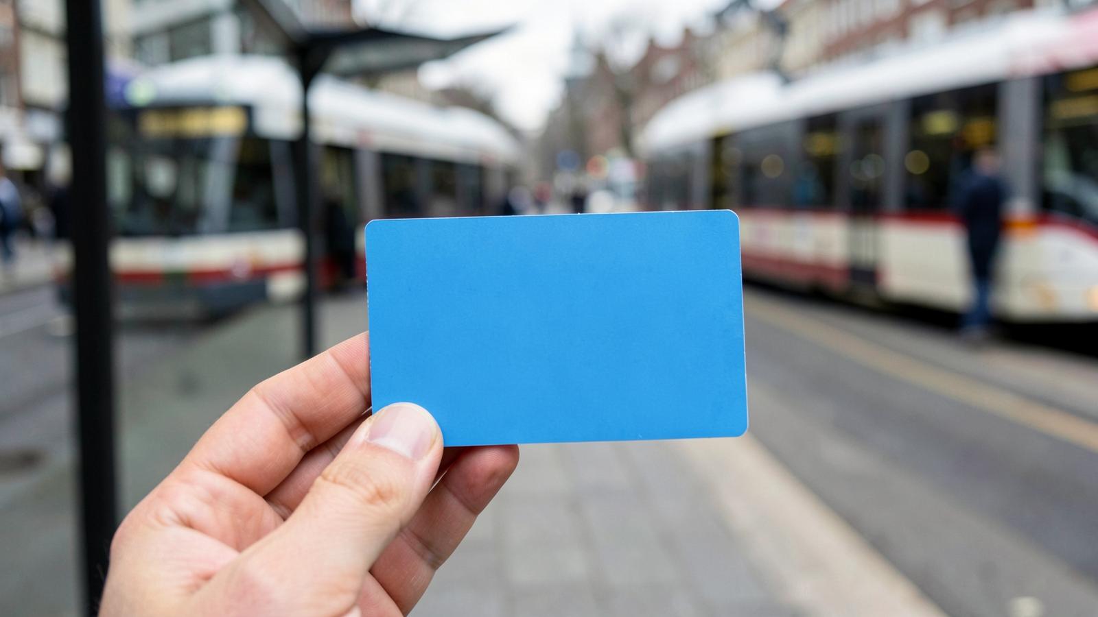 A hand tapping a bank card on a GVB contactless reader at a tram door in Amsterdam